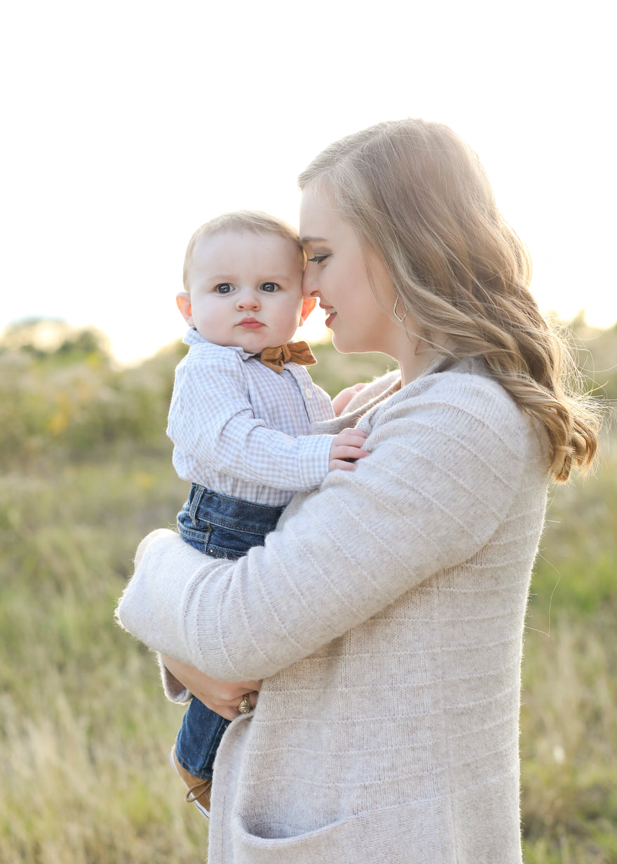 Mom nuzzling baby while holding him in her arms