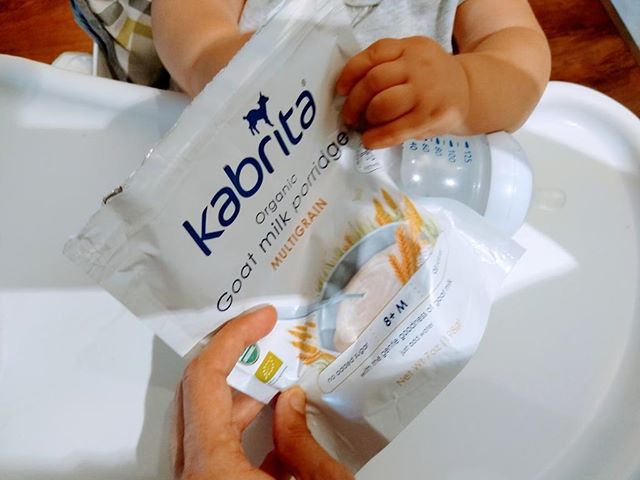 Toddler holding a bag of Kabrita Organic Goat Milk Porridge