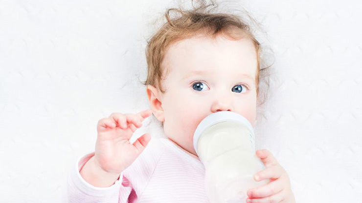 Baby drinking formula from bottle