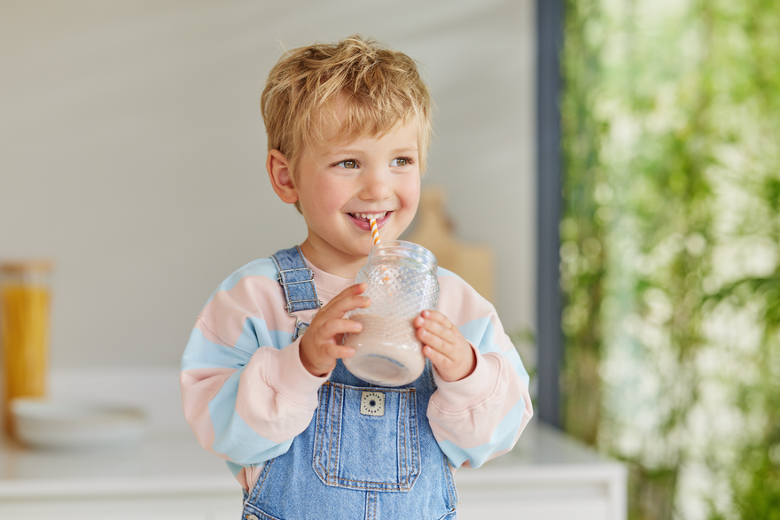 Little boy enjoying a smoothie with Kabrita Junior Nutrition